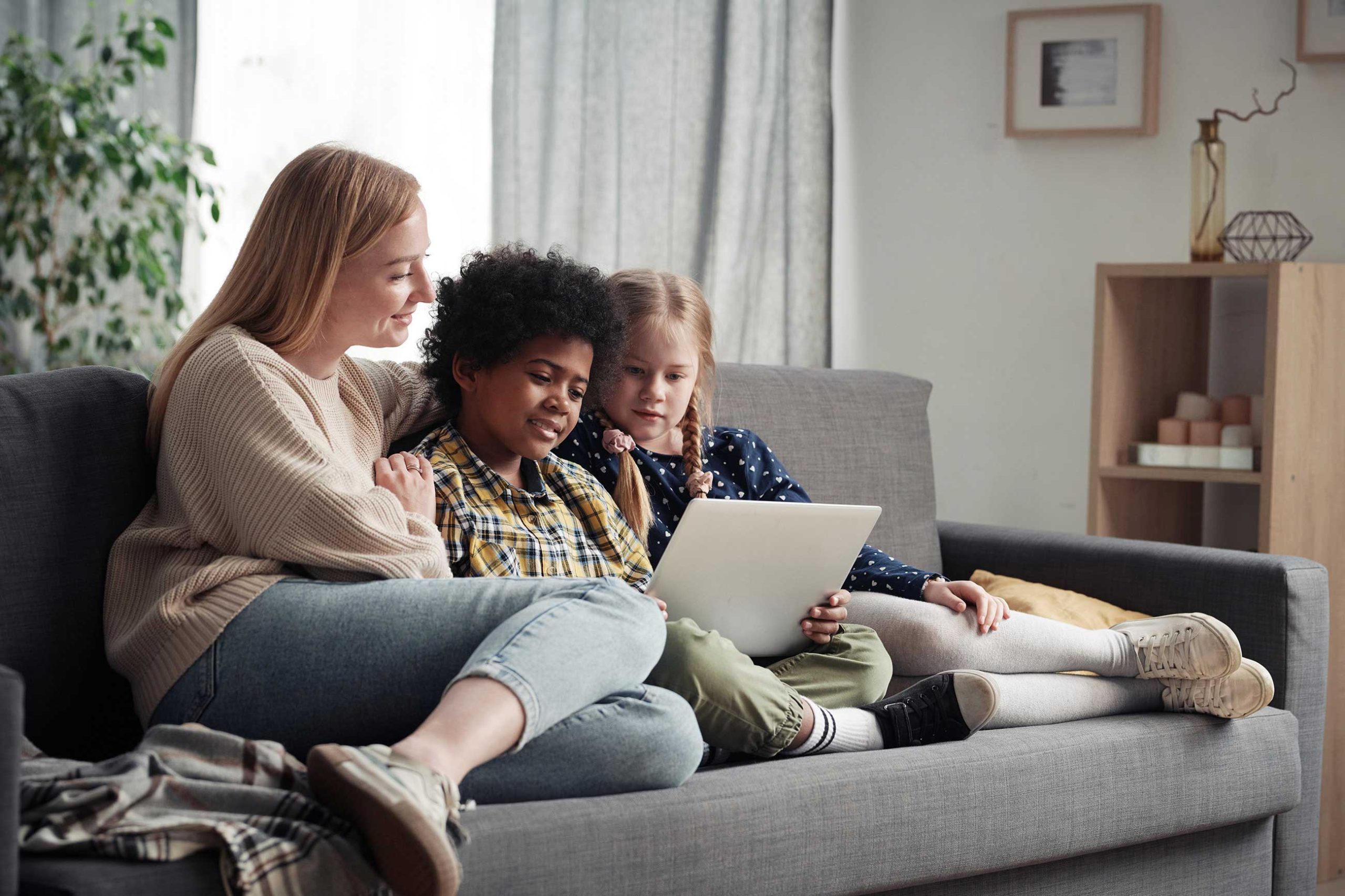 family-of-three-watching-movie-on-laptop